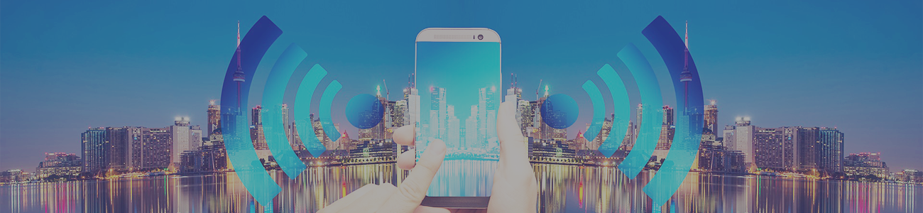 Hands holding mobile phone with cityscape background